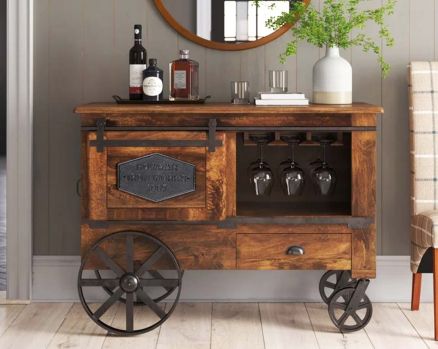 Wine cart/ bar with a vintage look in mango wood and powder-coated iron wheels with storage.
