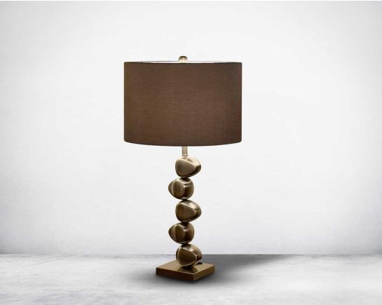 Table lamp standing with brown  graceful vivacity in sliver  metallic decorative base with translucent fabric shade.