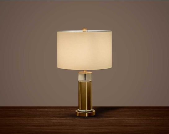 Table lamp with gold metal & glass base with translucent fabric shade.