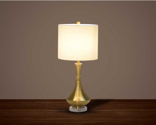 Table lamp in metallic gold and crystal with translucent fabric shade.