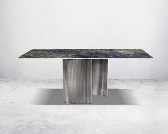 This sleek 8 seater glamorous dining table is crafted with an exclusive, gorgeous faux marble top. It has a fluted stainless steel base in artful design.