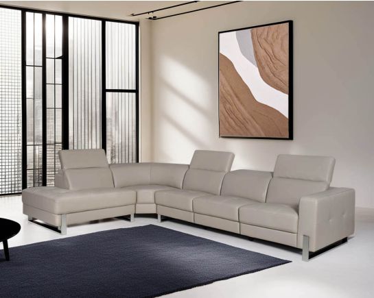 This luxurious L- shape sofa is very sleek, spacious, and provides ample comfort in a modern contemporary style. It is upholstered in fine quality leather with an adjustable headrest & stainless steel legs. Available in both left and right arm alignments.