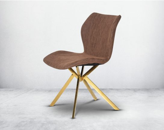 Dining chair upholstered in faux leather with high polished stainless steel legs plated in gold.