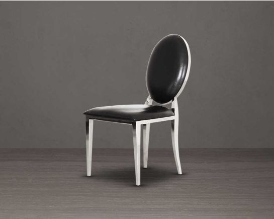 Dining chair upholstered in faux leather with stainless steel frame and legs.