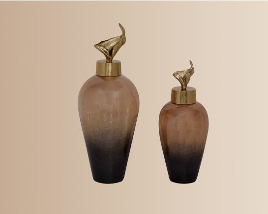 Decorative bottle in gold luster glass with ornamental aluminum lid.