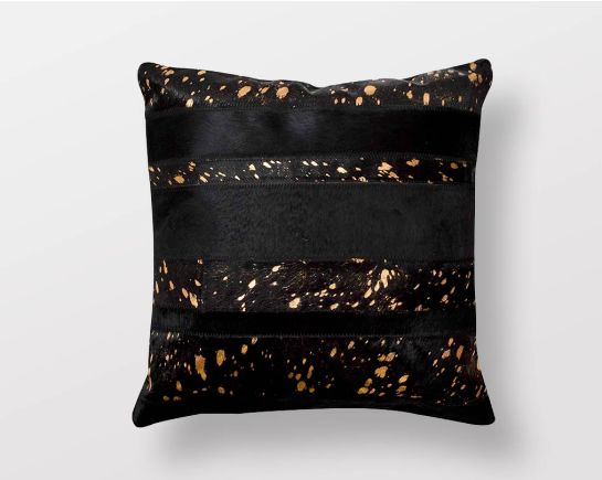 Black and copper hair on a leather cushion.