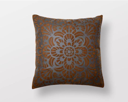 Brown and antique grey cut-out leather cushion.