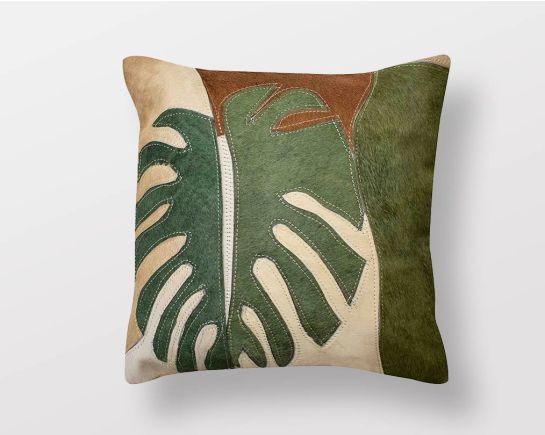 Beige and green hair on a leather cushion.