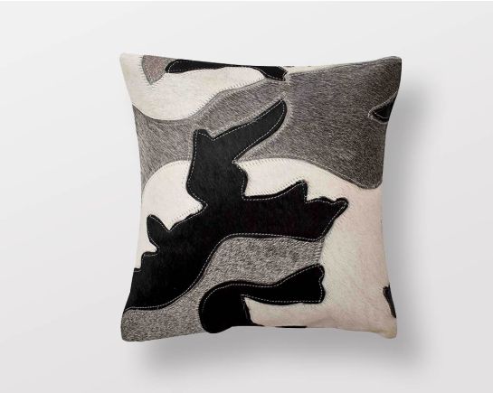 Black, white & grey hair on a leather cushion.