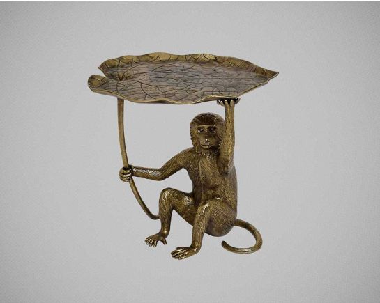 A sculptural end table made of solid Aluminium in antique gold finish with a leaf top motif & monkey design base with front view