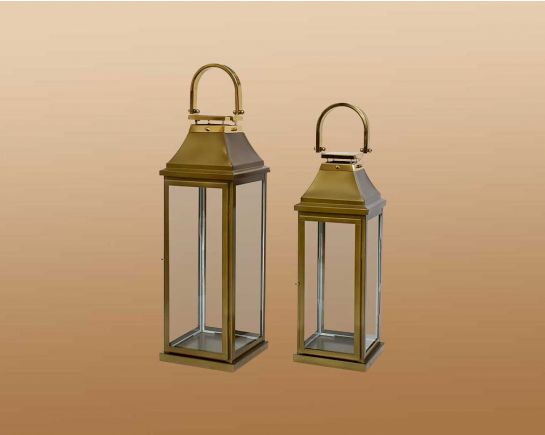 This lantern in modern classic style is crafted in Stainless steel finished in antique gold. It has clear glass & brass handles. This is a perfect mood setter enhancing any room with its glow.
