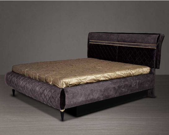 High back bed in king size in dark oak upholstered & quilted in fabric with antique gold design motif in modern classic design The bed comes with hydraulic lift storage.