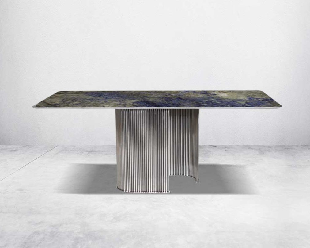 This sleek 8 seater glamorous dining table is crafted with an exclusive, gorgeous faux marble top. It has a fluted stainless steel base in artful design.